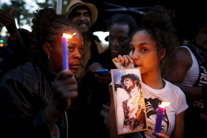 Julya Baer, 30, cries at a vigil to celebrate the life and music of deceased musician Prince in Los Angeles